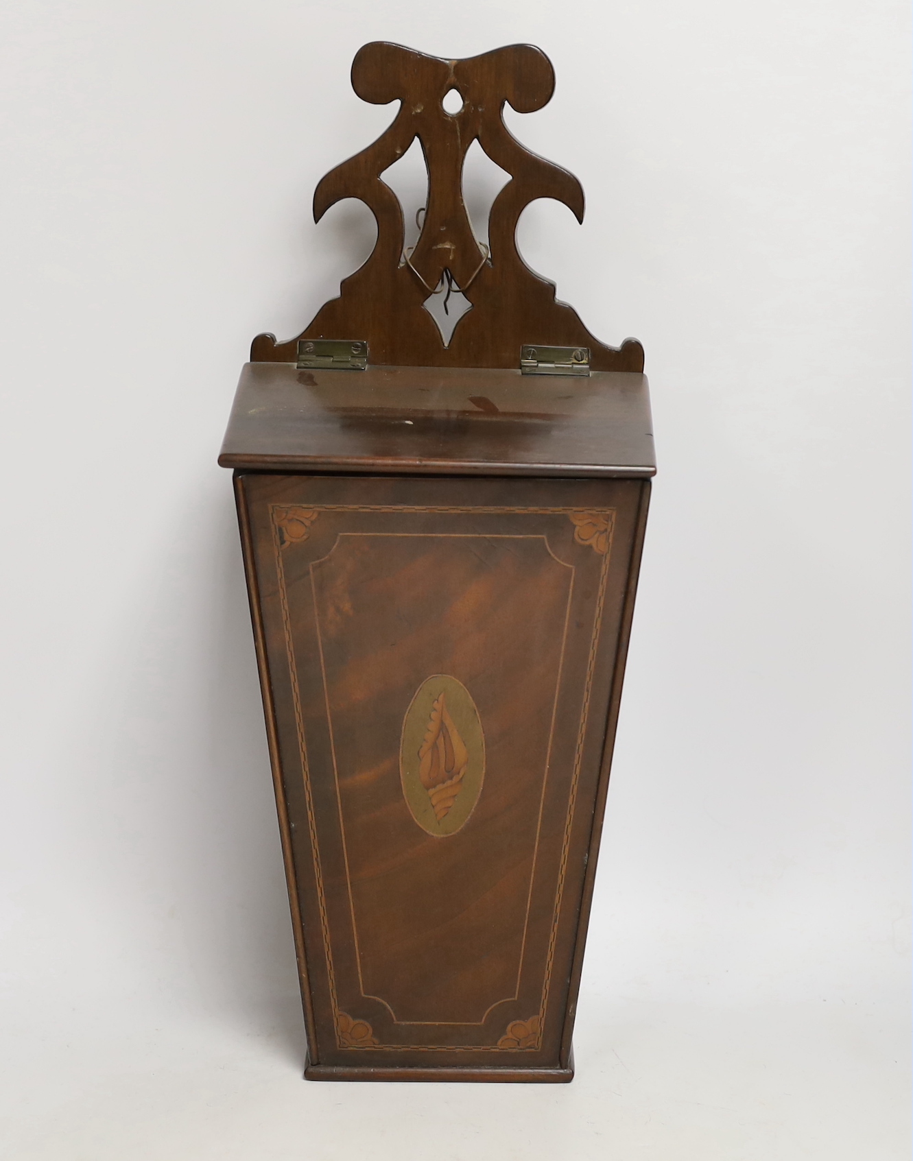 A 19th century mahogany wall hanging candle box, of tapering square form with inlaid stringing and shell decoration, 47cm